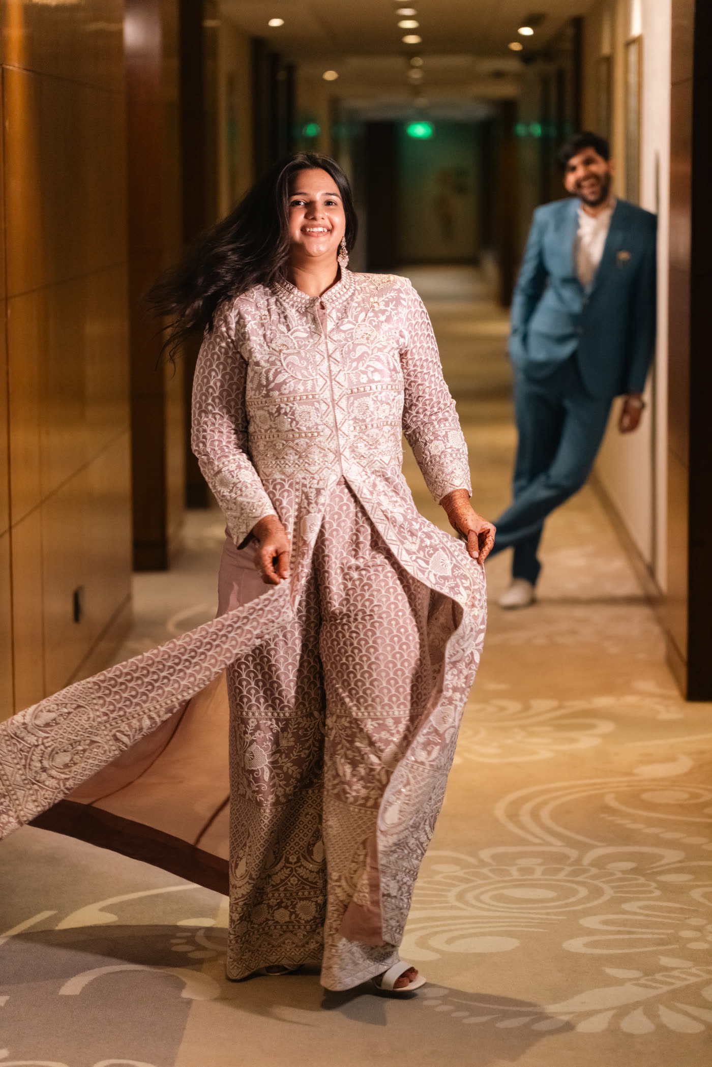 A bride mid-turn in a hotel corridor