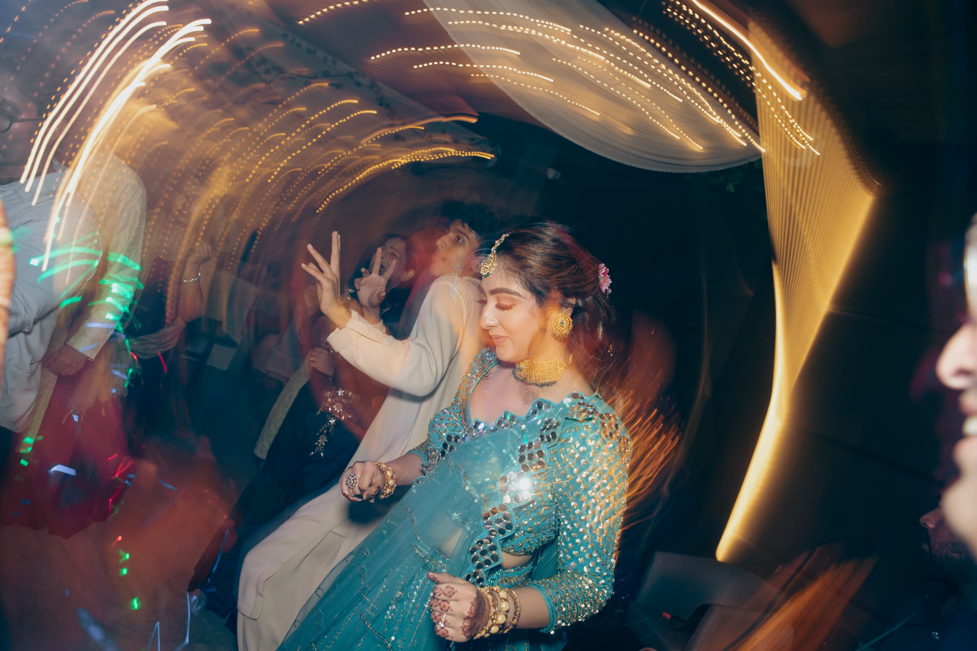 A couple wrapped in swirling sparkler light at their wedding